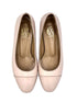 Pair of light pink shoes with a visible brand logo on a white background