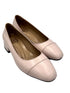 Pair of light pink shoes on a white background