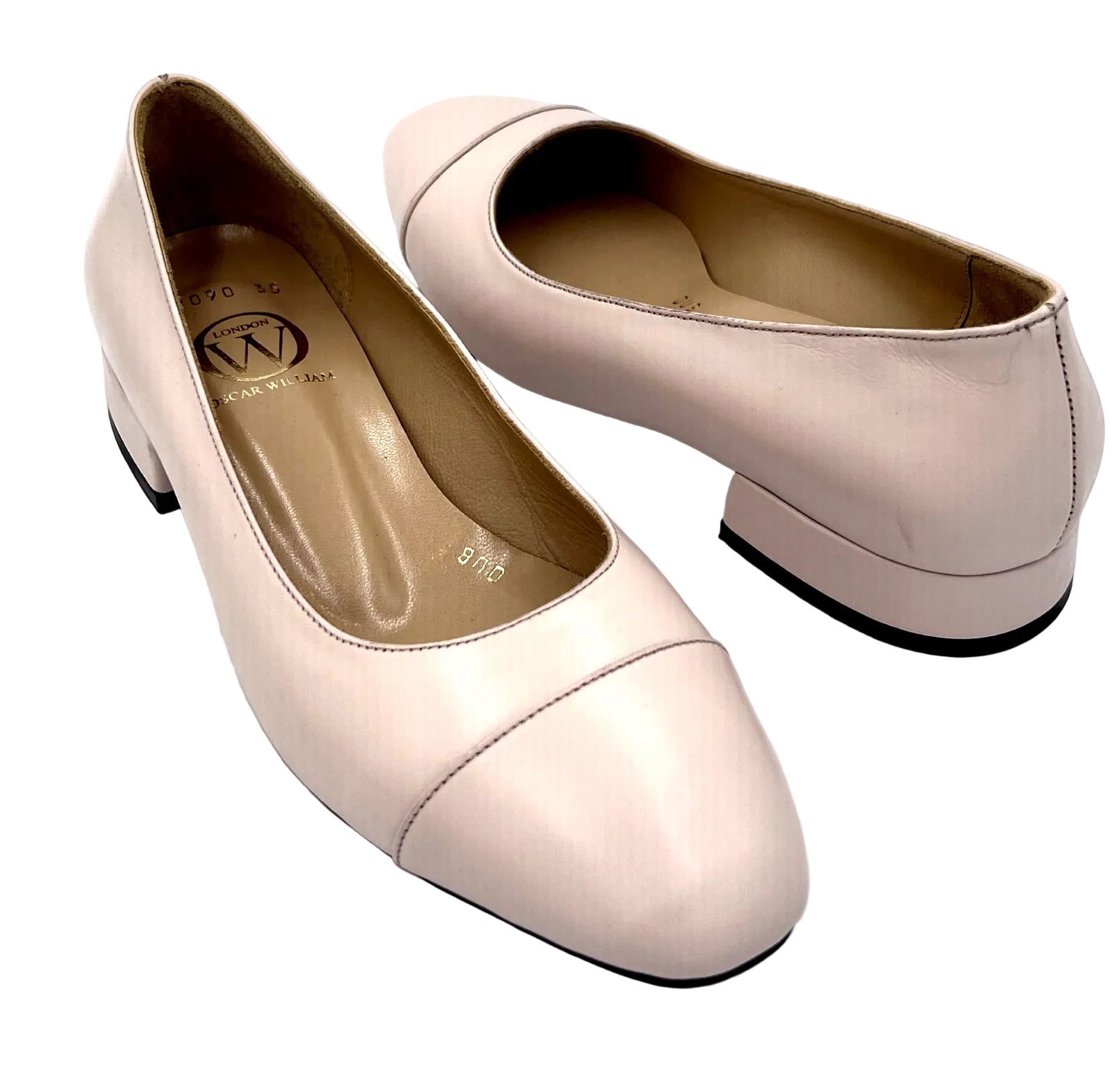 Pair of light pink shoes on a white background