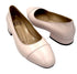 Pair of light pink shoes on a white background