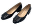 Pair of black shoes with a bow on a white background