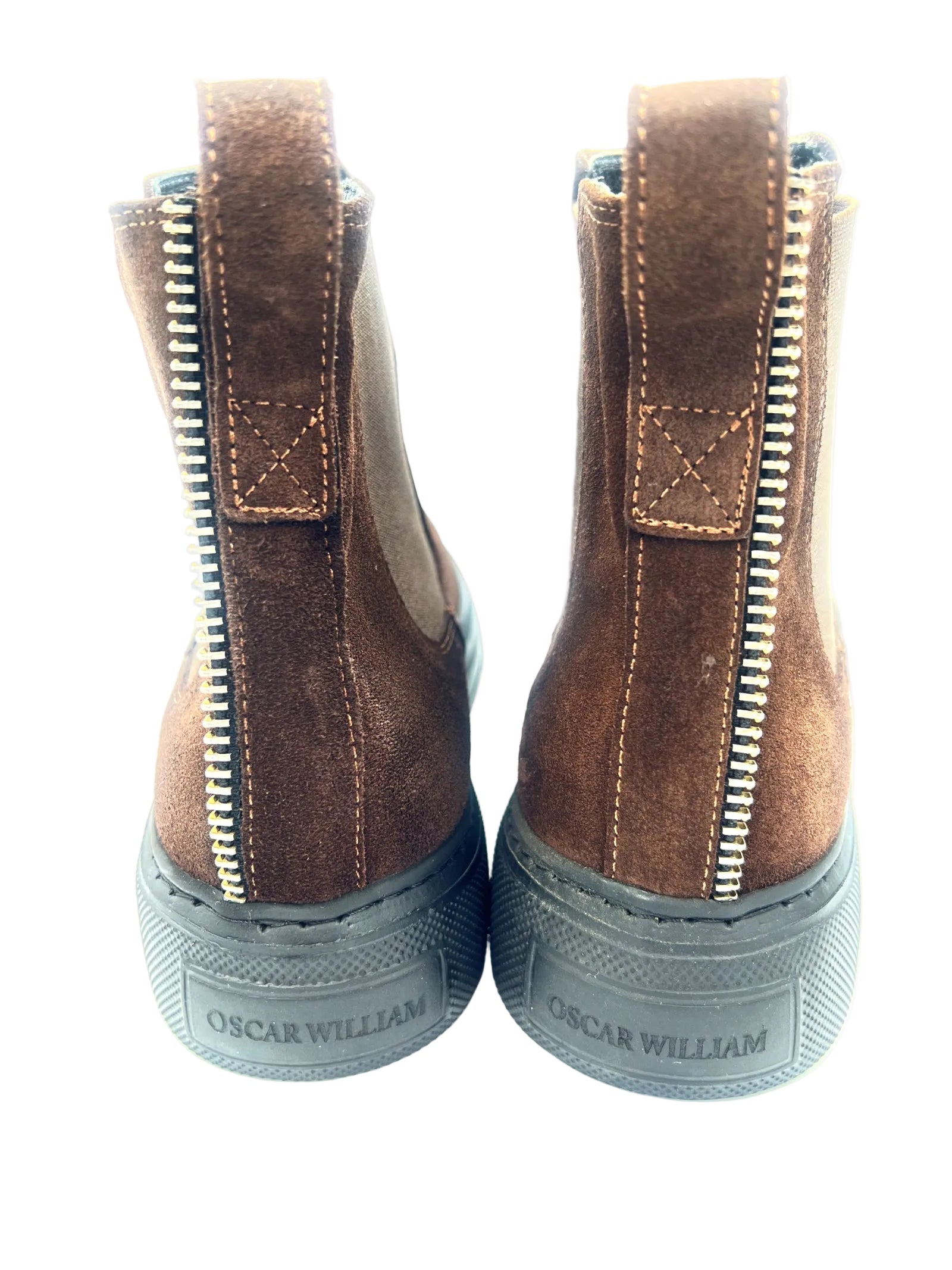 Pair of brown boots with zippers on a white background