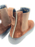 Brown suede boots with a zipper on a white background