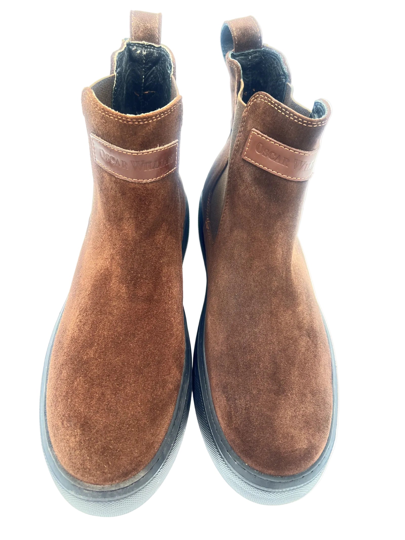 Pair of brown suede boots on a white background